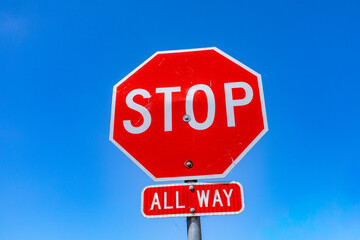 Obraz premium red stop sign with all way signage in California