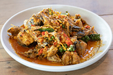 Spicy stir fried fish with chili, peppercorn and herbs, savory succulent seafood curry delight