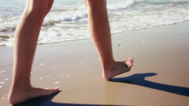 Video of close up of girl's legs walking on the beach