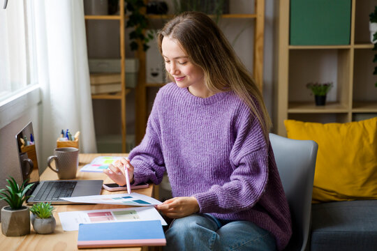 Creative woman planning at desk with color samples in natural light