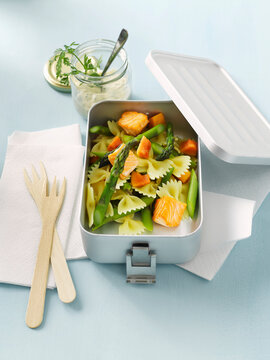 Farfalle pasta salad with salmon and asparagus in lunch box to go