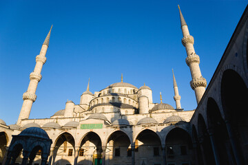 Blue Mosque domes and minarets from courtyard with Arabic inscription