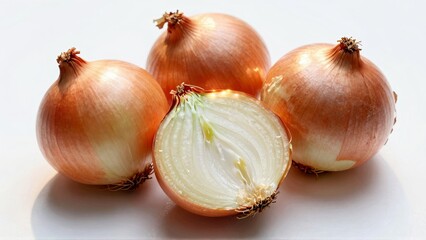 Whole and halved yellow onions on white surface
