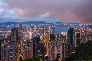 View of Hong Kong and Kowloon from Victoria peak. Evening, sunset. Panorama of Hong Kong, skyscrapers and nature. 21 May 2025, Hong Kong, China