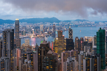 Naklejka premium View of Hong Kong and Kowloon from Victoria peak. Evening, sunset. Panorama of Hong Kong, skyscrapers and nature. 21 May 2025, Hong Kong, China