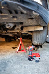 Jack stands under the car during repair vehical. Safety oil changing. High quality photo