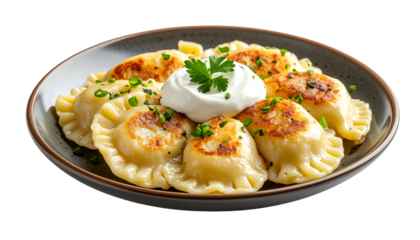 A plate of pan-fried dumplings with sour cream and chives garnish