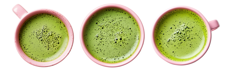 Frothy matcha green tea served in pink ceramic cup, from above isolated on white transparent background. Concept of healthy beverage