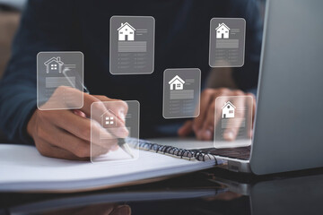 Person working on laptop and writing, surrounded by virtual house icons representing digital property management, real estate planning, or home loan applications and checklists.