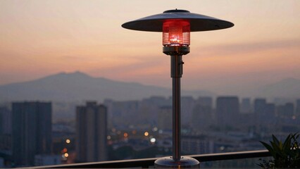 Patio heater glowing against city sunset backdrop