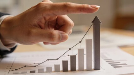 Business success rising bar chart with hand and finger pointing to growth graph showing upward trend and confident financial - Powered by Adobe