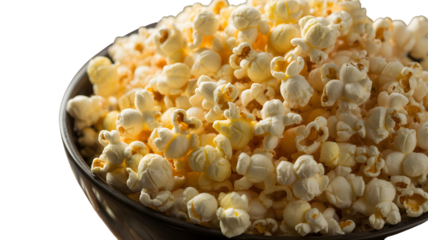 Close up shot of delicious buttery popcorn overflowing from a dark bowl against a stark black on transparent background. on transparent background