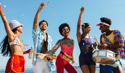 Friends celebrate Brazilian Carnaval on sunlit beach today