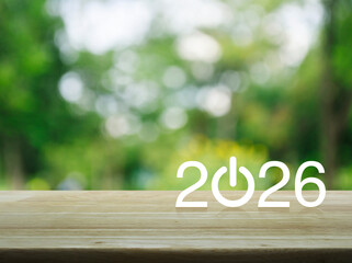 2026 start up business flat icon on wooden table over blur green tree in park, Happy new year 2026 success concept