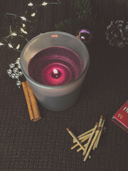 candle and cinnamon sticks