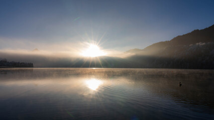 Obraz premium Frosty Sunrise over Weissensee in Bavaria Allgaeu Germany with great sunny Winter Vibes. High quality photo