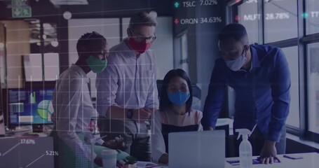 Stock market data processing over diverse office colleagues wearing face masks discussing at office - Powered by Adobe