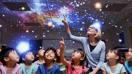 Classroom teacher and diverse children pointing projected galaxy ceiling during interactive astronomy lesson, children sitting with teacher planetarium classroom watching star projection ceiling