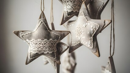 Close-up of handmade fabric star ornaments with delicate lace details, hanging against a soft, blurred background, evoking a rustic and festive charm.