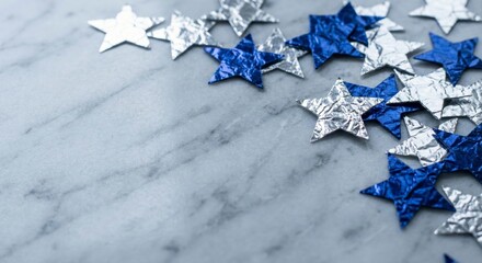 Silver and Blue Foil Stars Scattered on Marble Surface