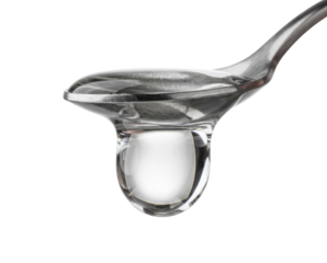 A close-up of a transparent spoon holding a droplet of water, showcasing clarity and precision against a dark background.