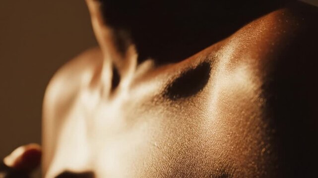 Close Up of Sweaty Skin with Golden Hour Lighting on Shoulders and Chest in Warm Tone with Visible Perspiration