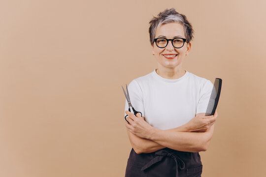 Woman hairdresser barber smiling holding scissors and comb