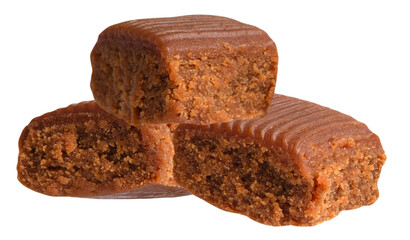 a stack of three delicious caramel fudge squares, showing their rich brown crumbly texture and ridged tops, presented on a solid transparent background in a tempting food display.
