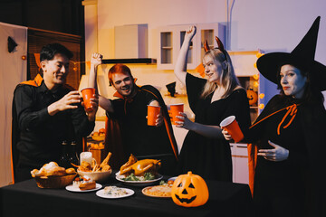 Friends enjoying a Halloween party at a bar making a toast