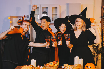 Friends enjoying a Halloween party at a bar making a toast
