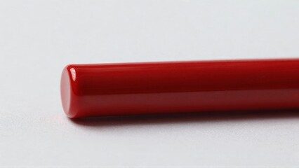 Red glossy cylinder on light surface