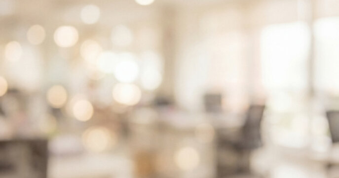A softly blurred view of a modern office space filled with warm light, showcasing blurred furniture and a vibrant atmosphere, ideal for creative work inspiration.