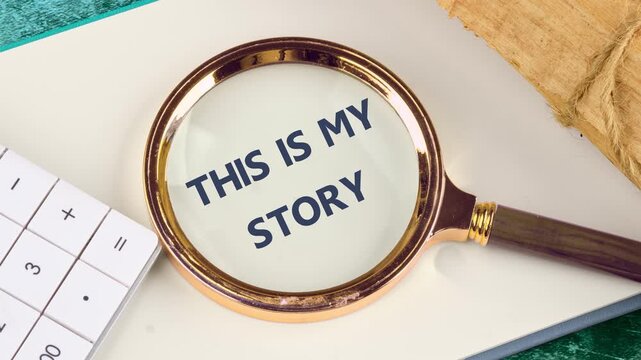 The appearance of the phrase This is my story through a magnifying glass on a blank sheet of a business book