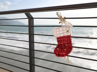 Christmas stocking on seafront promenade in old town of Monterosso, Cinque Terre, Italy. Nature, holidays and winter. Tourism and recreation in Liguria. 