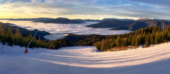 Snowy winter landscape in Austria During sunset abowe clouds. Stuhleck ski resort slope with cableway. Close to Vienna