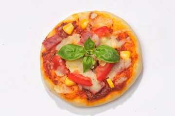 Homemade mini pizzas with smoked beef, tomatoes and mozzarella cheese