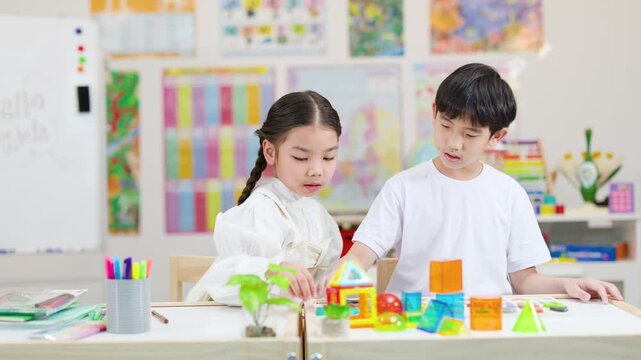 Children Building Colorful Blocks Together in Bright Classroom