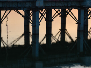 The bridge across the pond in the morning is under construction.