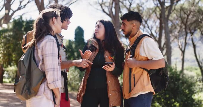 Friends, phone and lost in forest on hiking adventure, talk and stress for direction on vacation. Woman, frustrated group and point at smartphone, confused or search map with mobile app for trekking