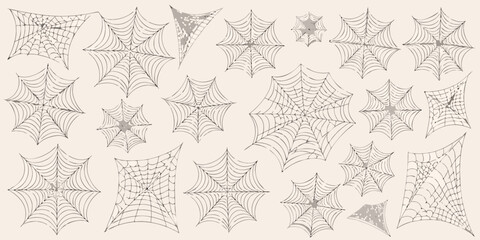 Numerous black spiderwebs scattered across a light beige background halloween theme