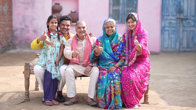 indian farmer family showing thumps up