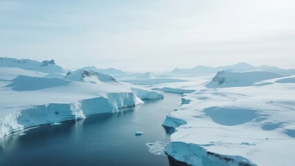 Obraz premium Polar scenery covered in ice and snow, with glaciers and snow-capped peaks, showing a cold and quiet natural landscape.