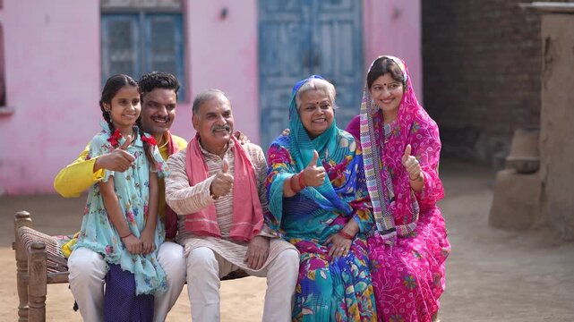 indian farmer family showing thumps up