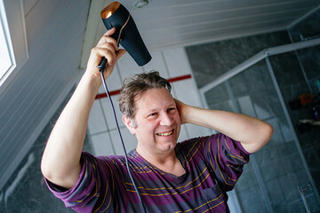Man doing morning bath routine, brushing teeth, shaving and washing hair.