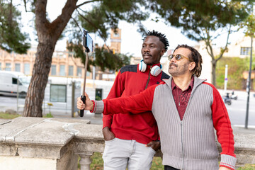 Diverse men travelers exploring city with paper map, finding directions on vacation