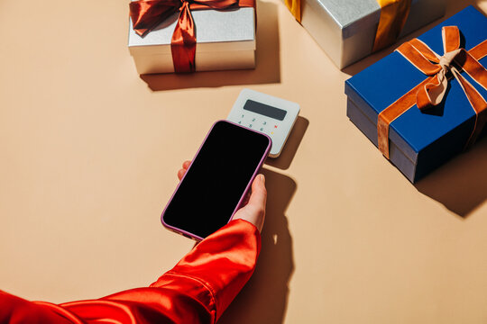 Contactless mobile payment with gift boxes in holiday shopping setting