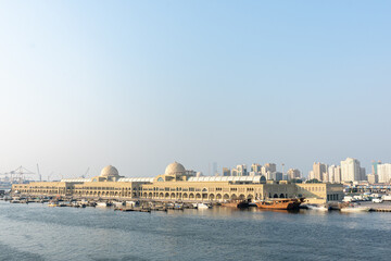 Souq Al Jubail, Sharjah, UAE,10.10.2025. Historic Market building stands along the waterfront with boats docked nearby.