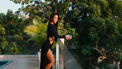 Empowered woman enjoying luxury lifestyle on a tropical resort balcony