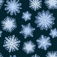 Seamless pattern with snowflakes. Light blue snowflakes on black night background.