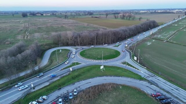 Aerial view of a busy roundabout intersection on a cloudy day in Italy